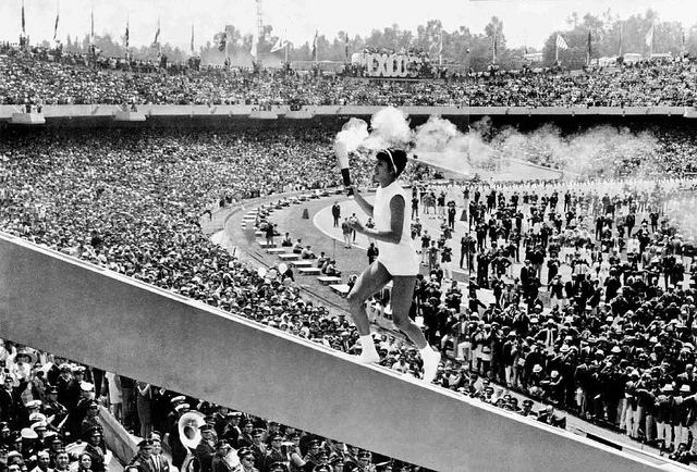 Norma Enriqueta Basilio running to light the Olympic cauldron.
