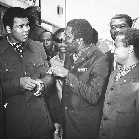 Ali, left, walking through the streets of Kinshasa in 1974.