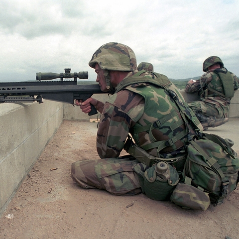 A U.S. Marine Corporal looks through a sniping rifle during a training in California in 2001.